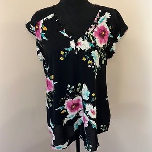 Fun floral Express top with cute button details around neckline.